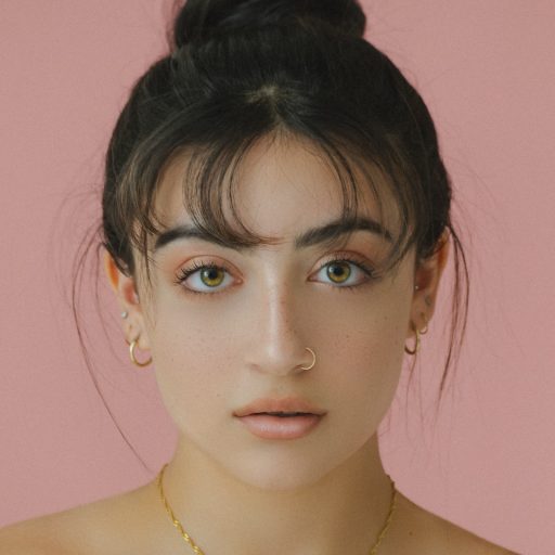 woman staring directly at camera near pink wall